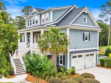 View of front of property with stairway, a garage, driveway, and a shingled roof