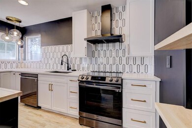 Kitchen with a sink, white cabinetry, stainless st