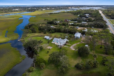 Aerial overview of property's location featuring a nearby body of water and nearby suburban area