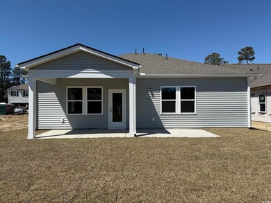Back of property featuring a lawn and a patio area
