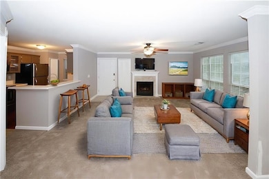 Living room featuring light carpet, baseboards, cr