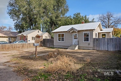 Bungalow featuring a metal roof and a chimney
