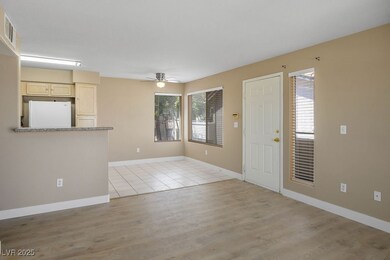 Entrance foyer with a ceiling fan, light wood-type