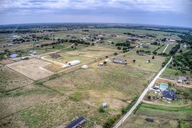 Back side view of 10 acres with land, home and cross fencing