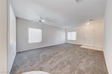 Carpeted empty room with visible vents and a ceili