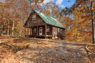 Chalet / cabin featuring a porch and a metal roof