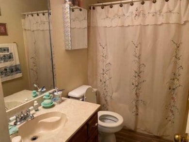 Bathroom featuring toilet, vanity, shower / bath c