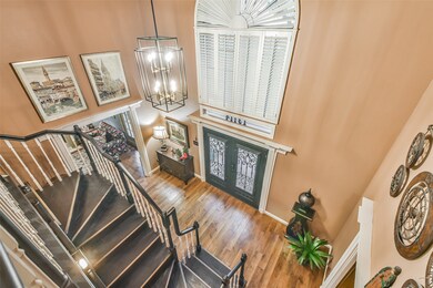 High ceiling entry with updated black/gold lighting, plantation shutters, decorative door moldings and Karndean Flooring!