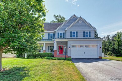 View of front of home featuring asphalt driveway,
