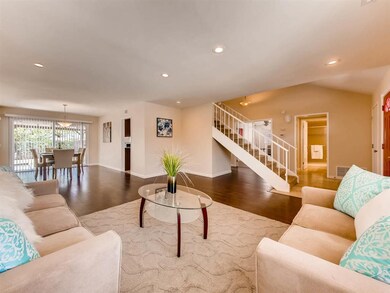 Living room looking into dining room & staircase a