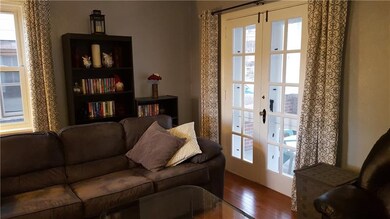 FRENCH DOORS TO COVERED FRONT PORCH.
