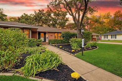 Front of house with brick siding and a front yard