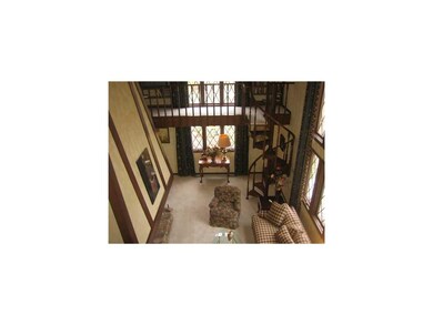 Living Room. Living room w/ spiral staircase leadi