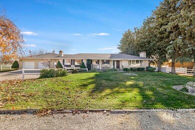Ranch-style house with a chimney, driveway, and a garage