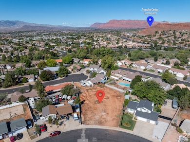 Aerial view of property and surrounding area with nearby suburban area and a mountain backdrop