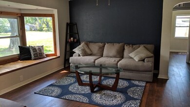 View of living room from eating area.  Down the ha