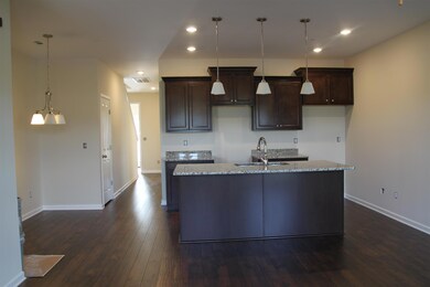View of the kitchen from the great room.  Similar home.