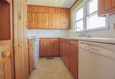 Kitchen with visible vents, a sink, light countert