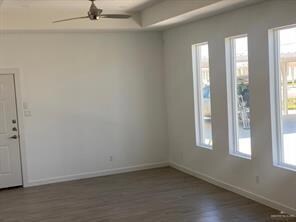 Empty room with ceiling fan and dark hardwood / wo