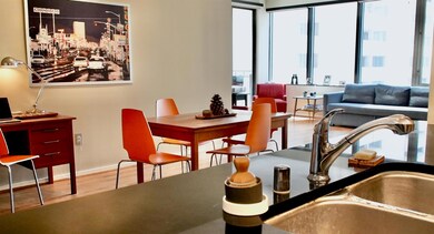 Dining space with sink and wood-type flooring