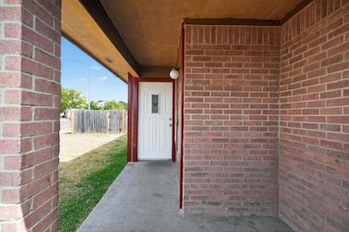 Property entrance with brick siding