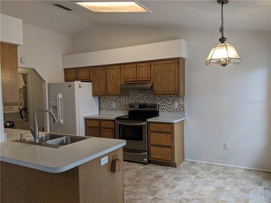 Eat-in Kitchen with tile backsplash and vaulted ce