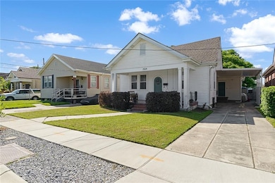 Notice long driveway and covered carport parking.