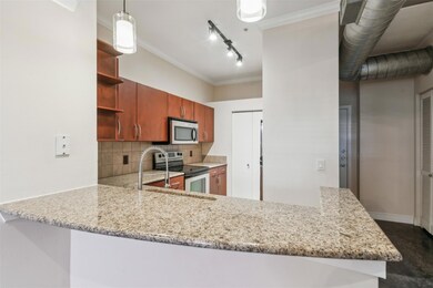 Kitchen with kitchen peninsula, backsplash, applia