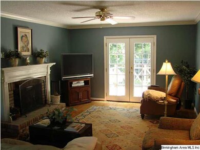 Family room with brick surround gas fireplace and 