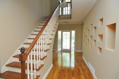 Step inside and be greeted by gleaming hardwood fl