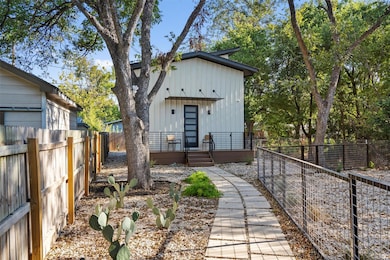 View of front of house with a fenced backyard, bo