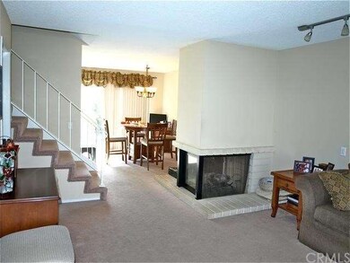 3-sided fireplace separates family room and dining
