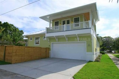 Exterior Back - Two car garage with side entrance.  Garage opens to alley that runs behind the home.