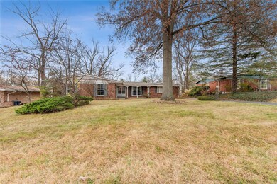 Home sits on a level lot with mature trees.