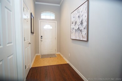 Entry door with a high arched transom window let's