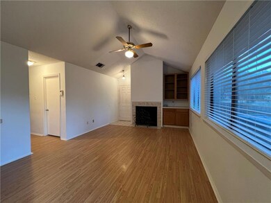 Unfurnished living room featuring a fireplace, ce