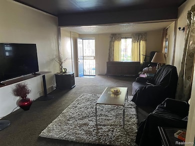 Carpeted living area with a textured ceiling