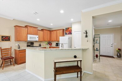 Kitchen with granite counters, light tile patterne