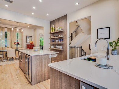 Kitchen featuring open shelves, light wood-style 