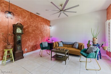 Living area featuring ceiling fan, tile patterned