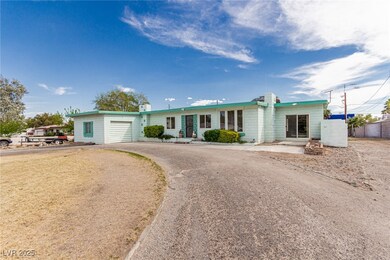 Ranch-style home featuring aphalt driveway and an