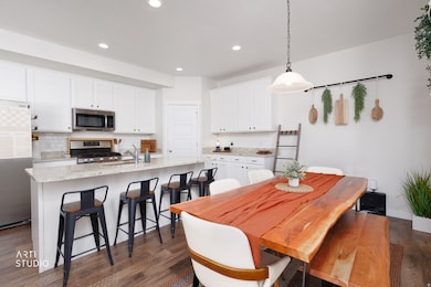 Spacious dining room featuring LVP flooring and recessed lighting