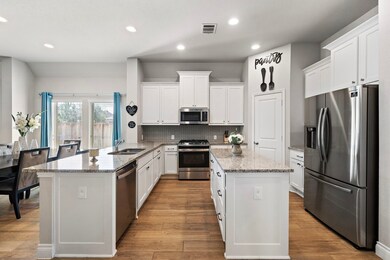 The kitchen also featuring a kitchen island and pl