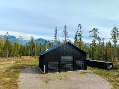 View of outbuilding with a forest view and a mountain view
