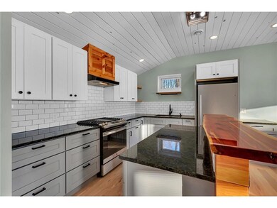 The kitchen has all new cabinetry, backsplash, app