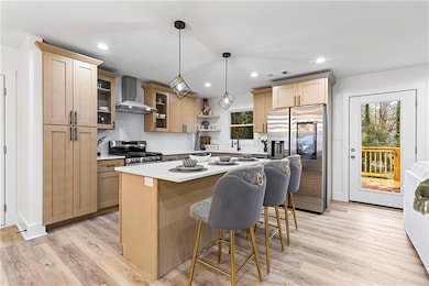 Kitchen with visible vents, a breakfast bar area, 