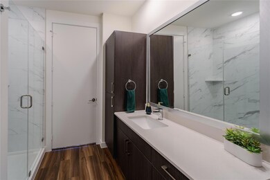 Bathroom featuring vanity, wood finished floors, 