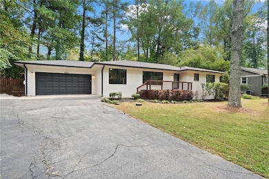 Ranch-style home with a front yard and a garage