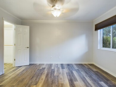 Unfurnished room with baseboards, wood finished f