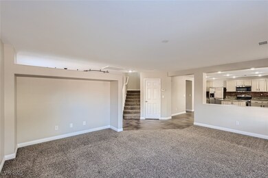 Unfurnished living room featuring stairway, basebo